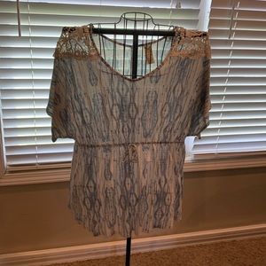 Adorable shirt with a tie waist and lace on the shoulders.